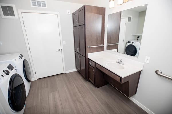 Modern bathroom with laundry facilities and mirrors