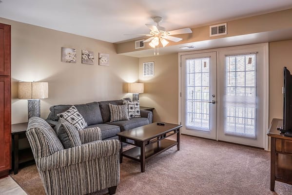 Cozy living room with couch and table in assisted living facility