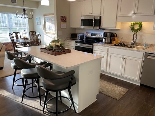 Bright kitchen area with modern appliances and seating