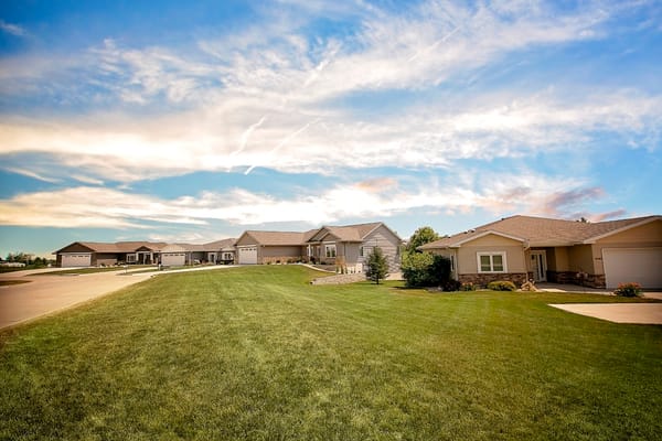 View of a well-kept exterior with homes and greenery