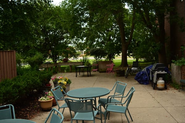 Outdoor patio area with seating and floral arrangements