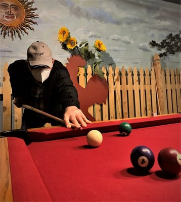 Resident playing billiards in a recreational area