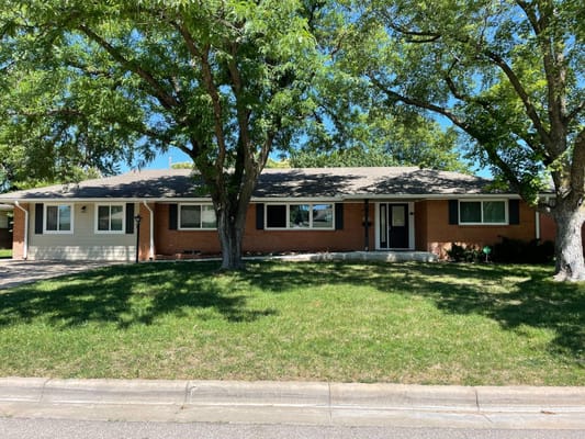 Front exterior of Keepsake Kottage surrounded by trees and green grass