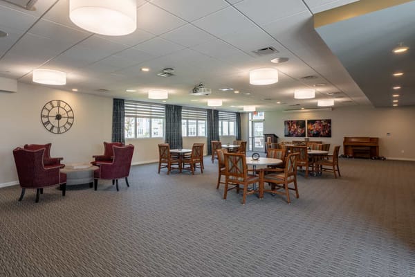 Common dining area with seating and windows