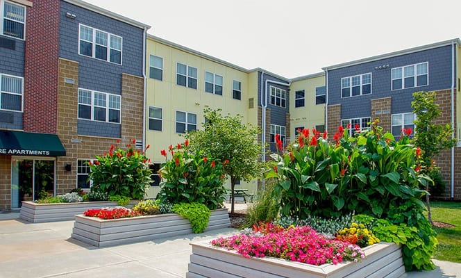 Exterior view of Prime Square Apartments with gardens