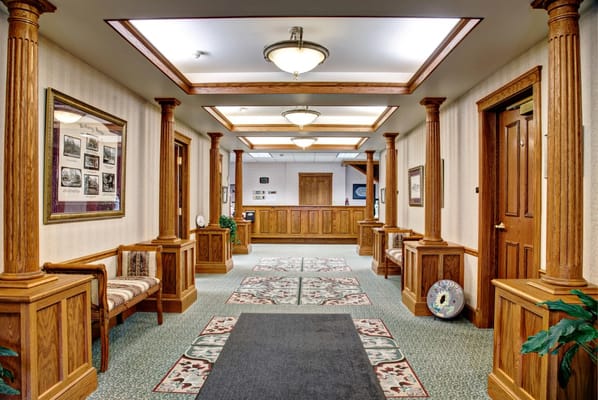Interior hallway of the facility with wooden columns and seating areas