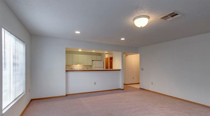 Spacious living room with a view of the kitchen area