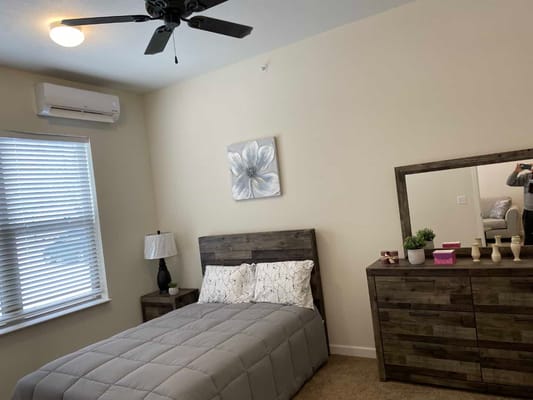 Cozy private resident room with bed and dresser