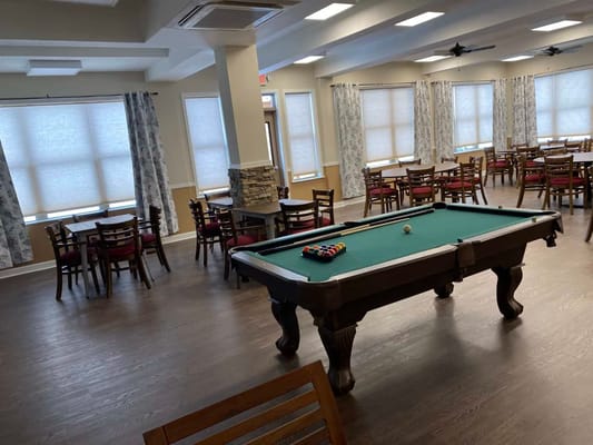 Interior view of a pool table and dining area