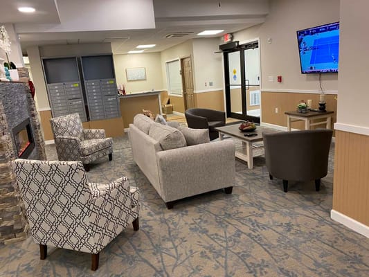 A cozy common area with seating and a television
