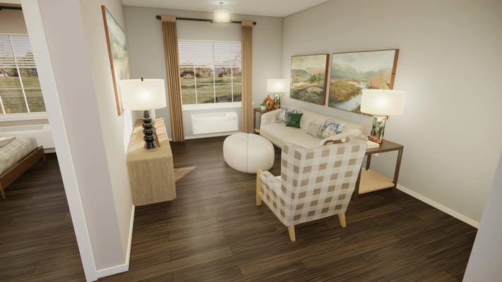 Bright living room with a sofa, armchair, and artwork