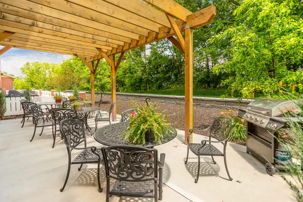 Outdoor patio area with seating and greenery