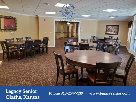 Seating area with wooden tables and chairs in a senior living facility