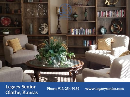 Cozy lounge area with comfortable chairs and bookshelves.