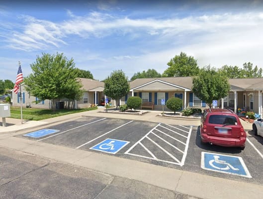 Exterior view of Cottages of Topeka senior apartments with accessible parking