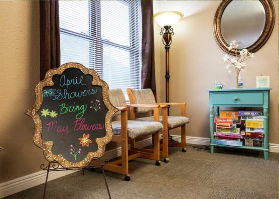 Chalkboard sign in a cozy common area with seating