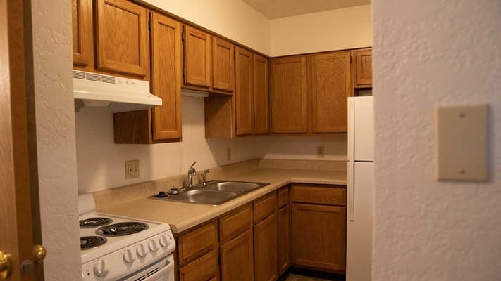 Kitchen area with wooden cabinets and appliances
