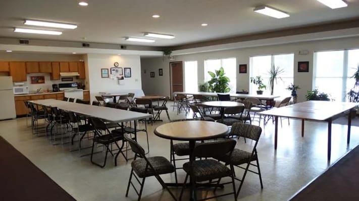 Interior view of a large common area with tables and chairs