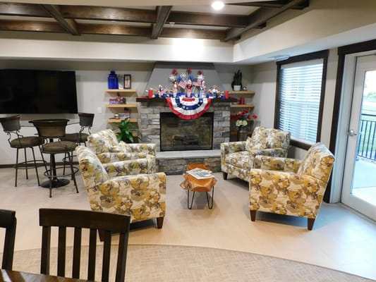 Common area with chairs and decorative fireplace