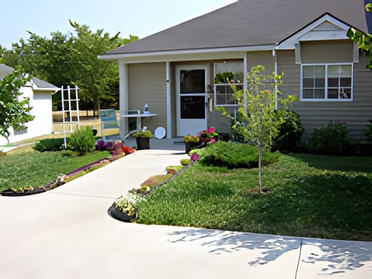 Well-maintained pathway leading to the front entrance of Peterson Acres.