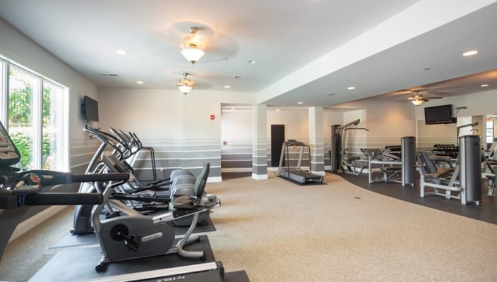 Well-lit interior view of a fitness room with equipment