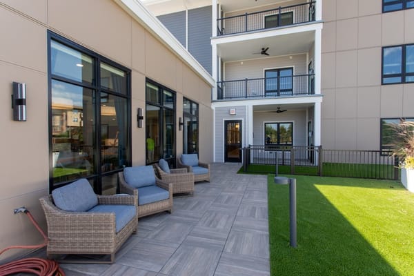 Outdoor seating area with chairs and grass