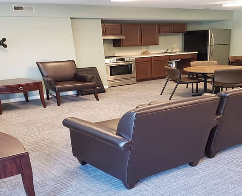 Cozy common area with seating and kitchen visible