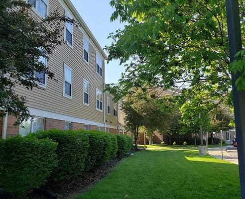 Exterior view of Garden Grove Apartments surrounded by greenery