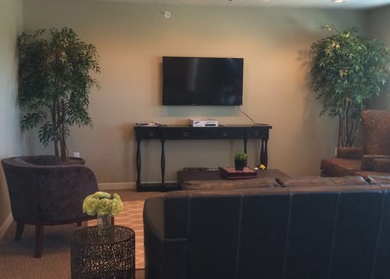 A cozy common area with seating and plants