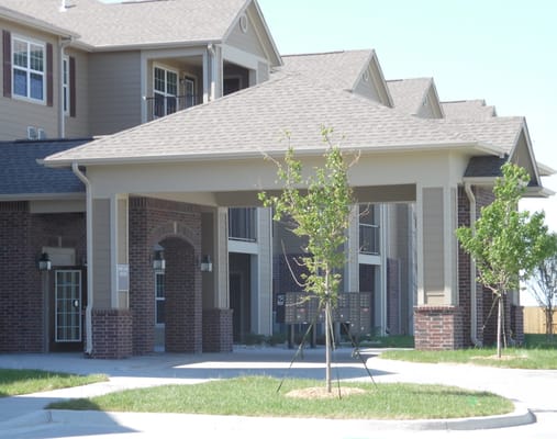 Covered entrance of Birchwood Villas with landscaping
