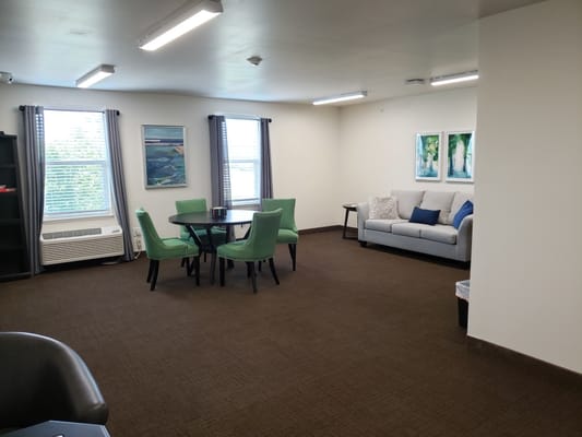 Bright common area with seating and artwork