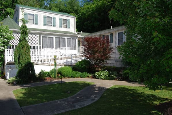 Exterior view of a senior living facility with gardens