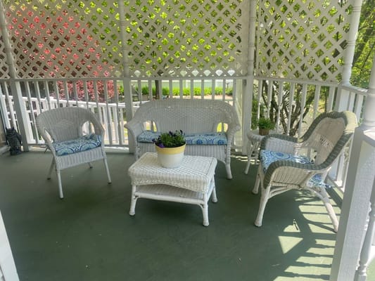 A peaceful outdoor seating area with wicker chairs