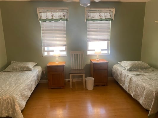 Shared resident room with two beds and lamps