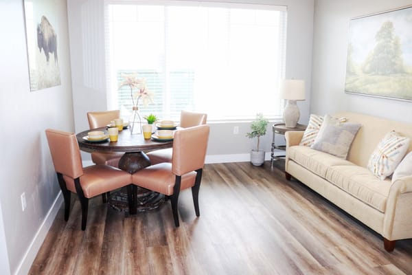 Bright and inviting interior common area with seating and dining space