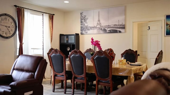 Dining room with ornate chairs and a clock on the wall