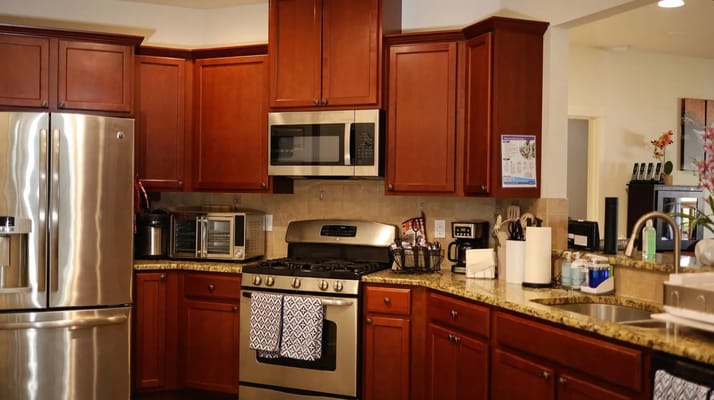 Bright kitchen with stainless steel appliances and wooden cabinets
