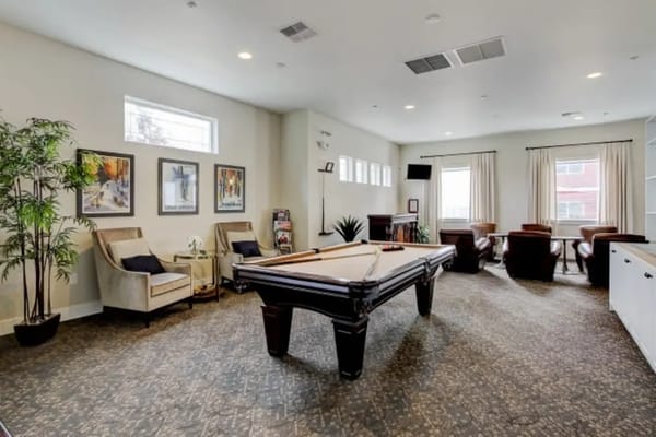 Interior of the game room with a pool table and seating areas