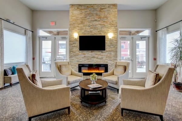 Comfortable seating area with a stone fireplace