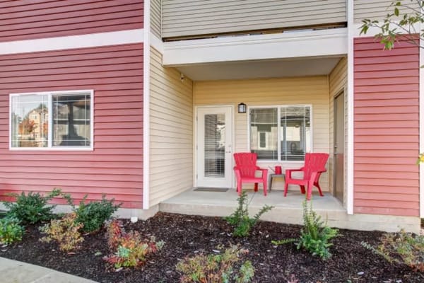 Outdoor patio with red chairs at LARC at Olympia