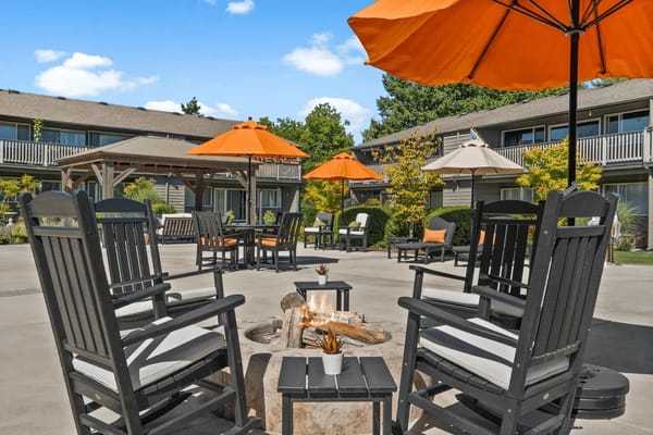 Outdoor space with rocking chairs and umbrellas