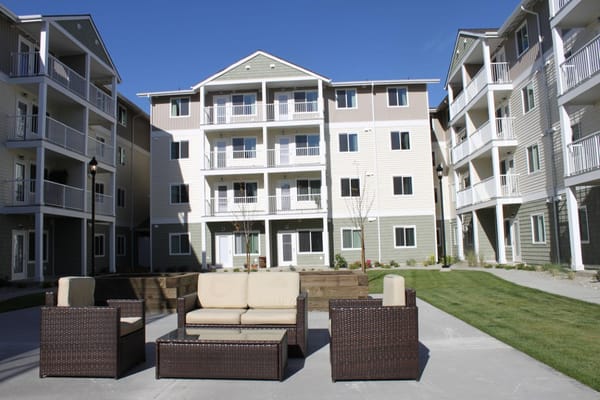 Outdoor seating area with residential buildings in background