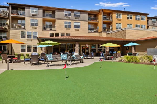 Outdoor space with seating and putting green