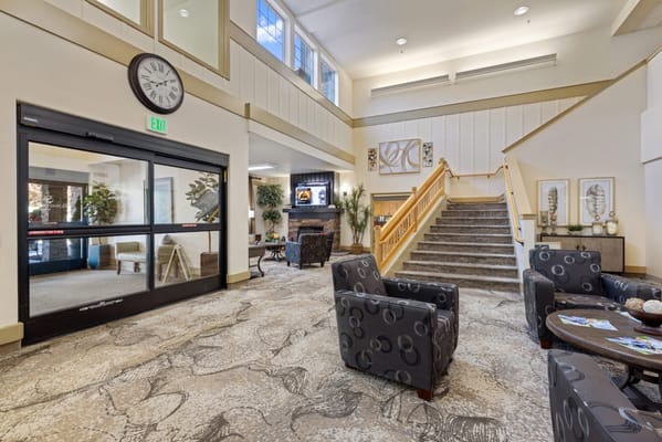 Bright lobby area with comfortable seating and stairs