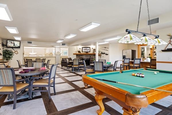 Residents engaging in a game of billiards in the common area