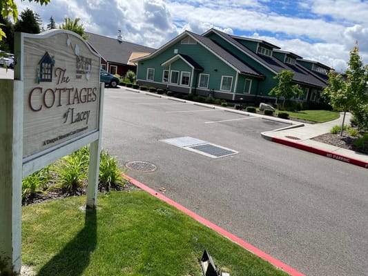 Exterior view of The Cottages of Lacey with signage