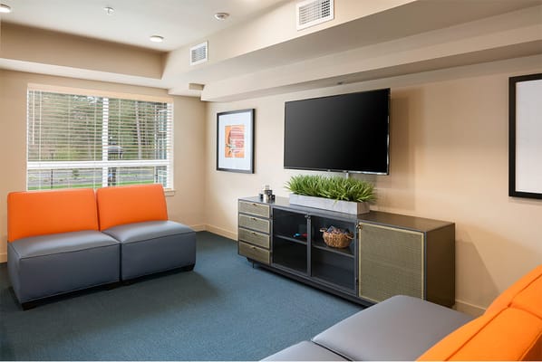 Bright common area with seating and television
