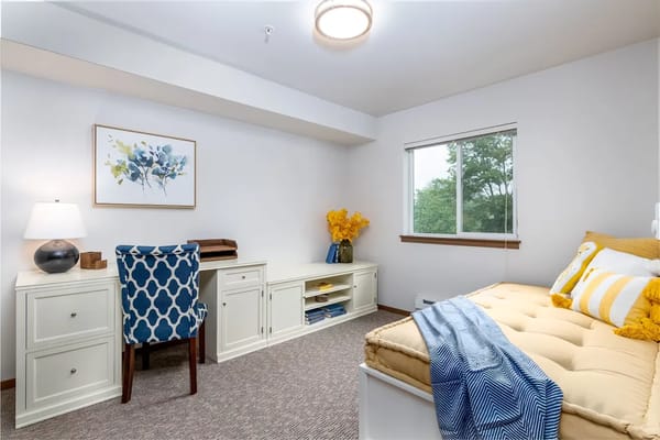 Bright and welcoming resident room with furnishings