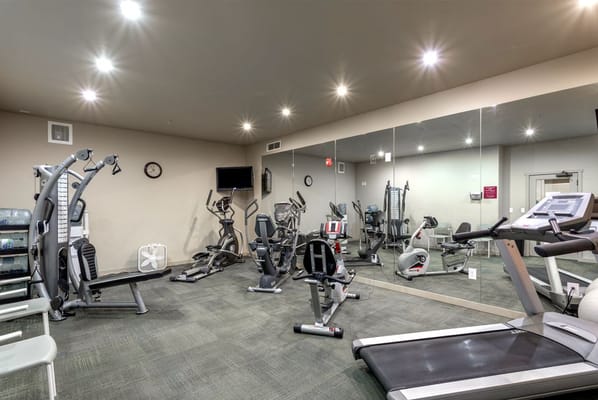Well-equipped fitness room with exercise machines