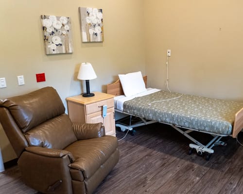 Private resident room with a bed and recliner